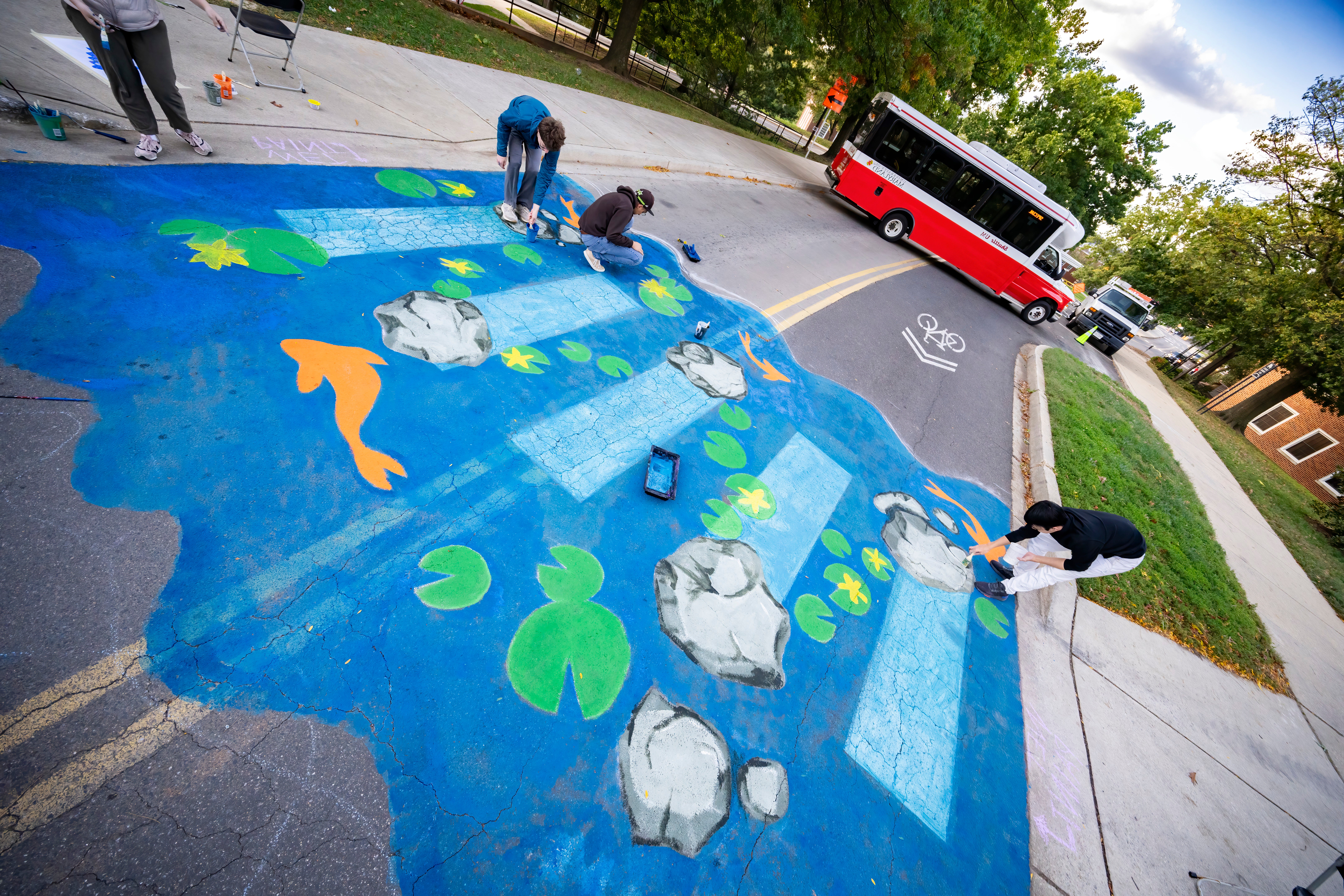 Crosswalk painted as pond with lilly pads